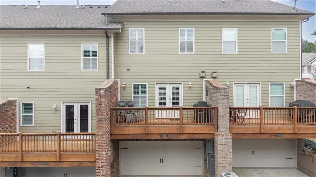 Back of property featuring a garage and french doors