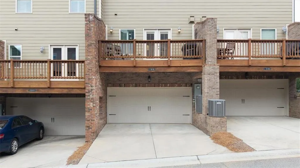 Back of house featuring cooling unit, a garage, and french doors