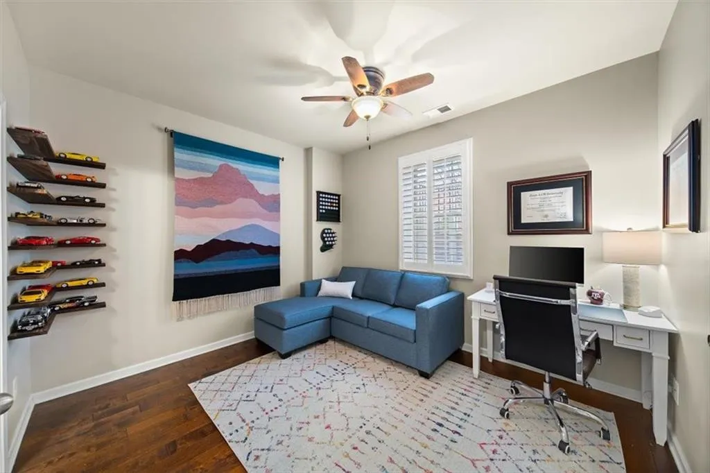 Office space featuring hardwood / wood-style floors and ceiling fan