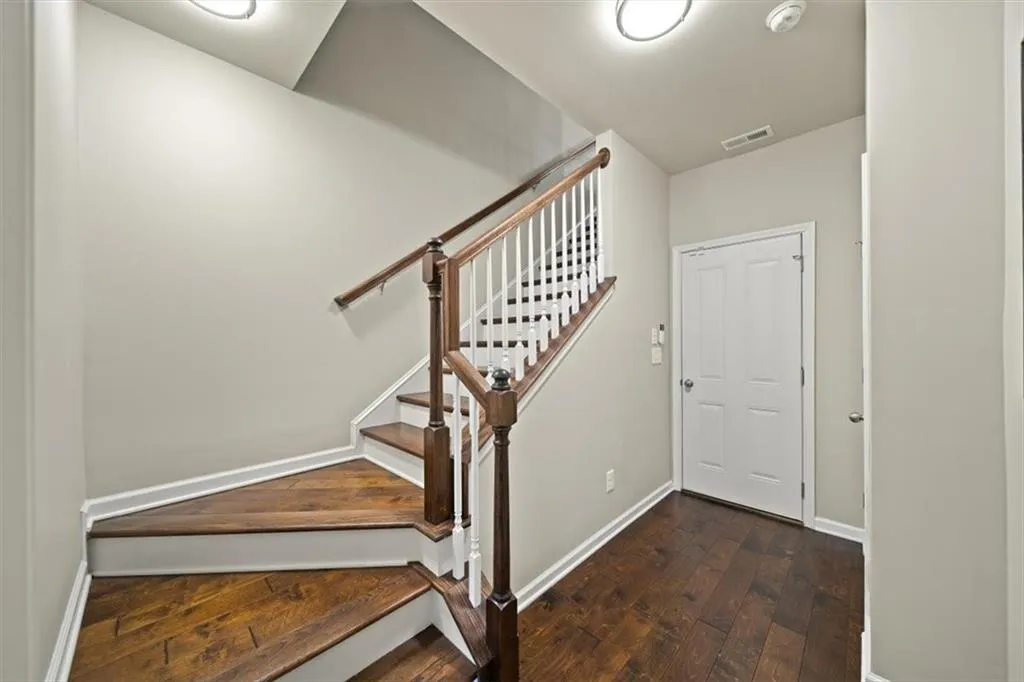 Staircase featuring hardwood / wood-style floors