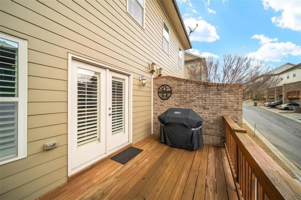 Wooden terrace with a grill and french doors