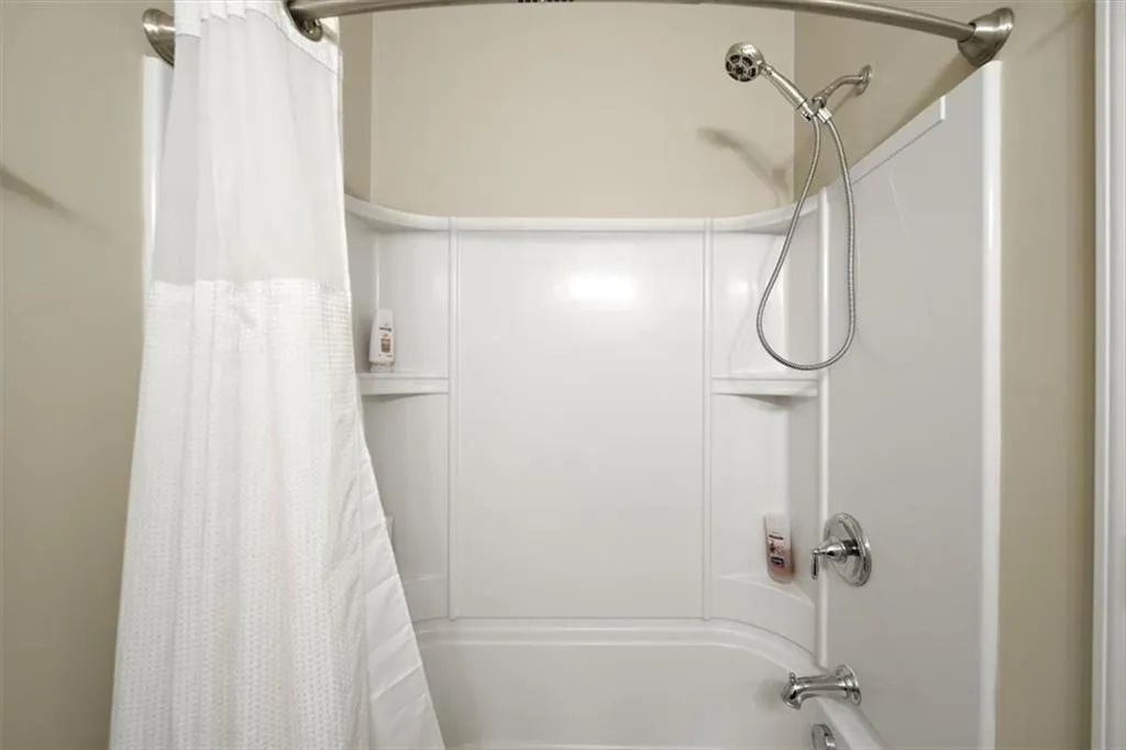 Bathroom with shower / bath combination with curtain