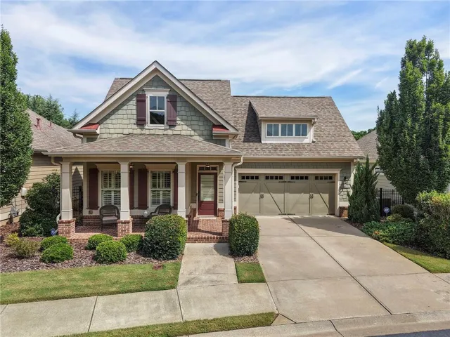Craftsman-style exterior with a covered porch, brick accents, and a dormer window
