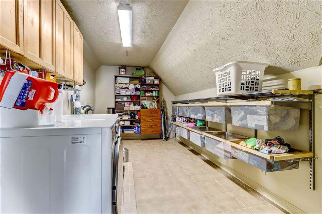 Coveted Upstairs laundry room with more amazing Elfa storage systems