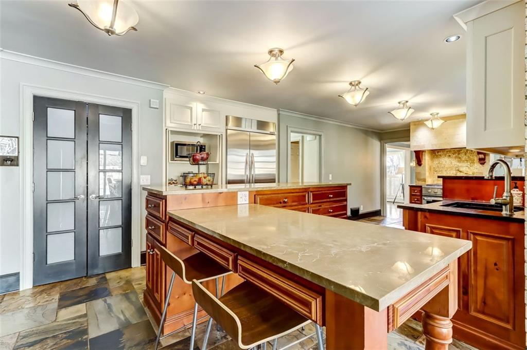 View of the stainless steel refrigerator and foyer to make cooking in here a dream