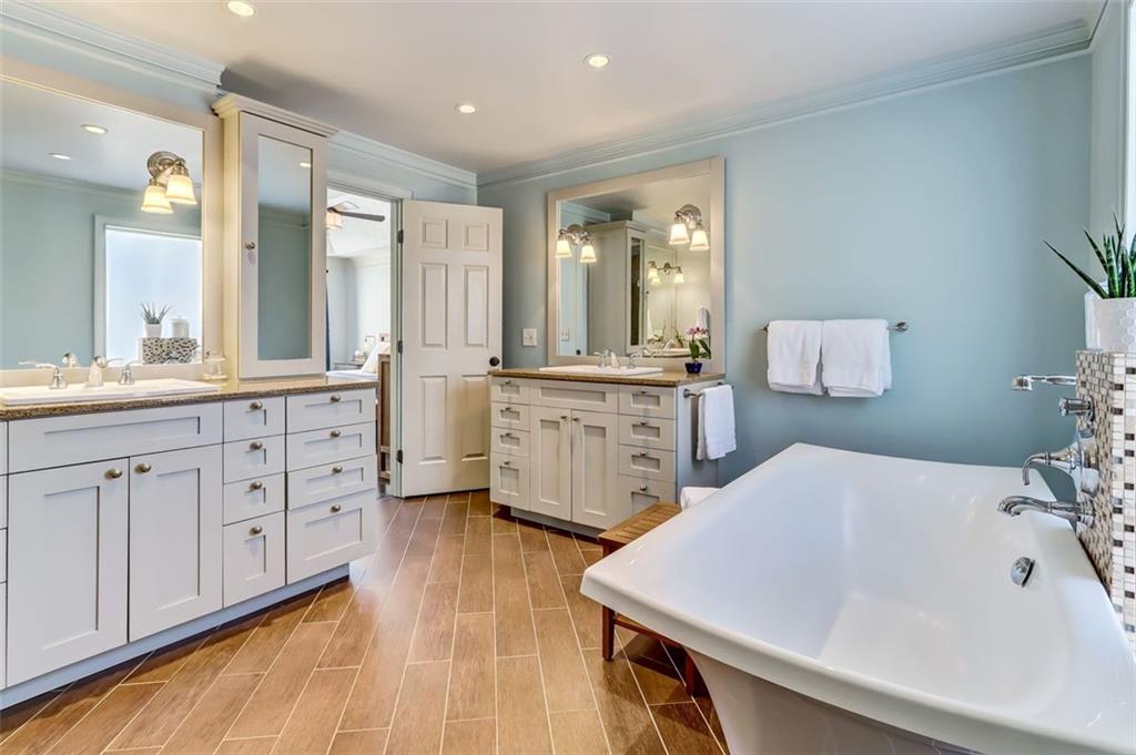Dual vanities & soaking Tub also displays the heated tile flooring for your comfort