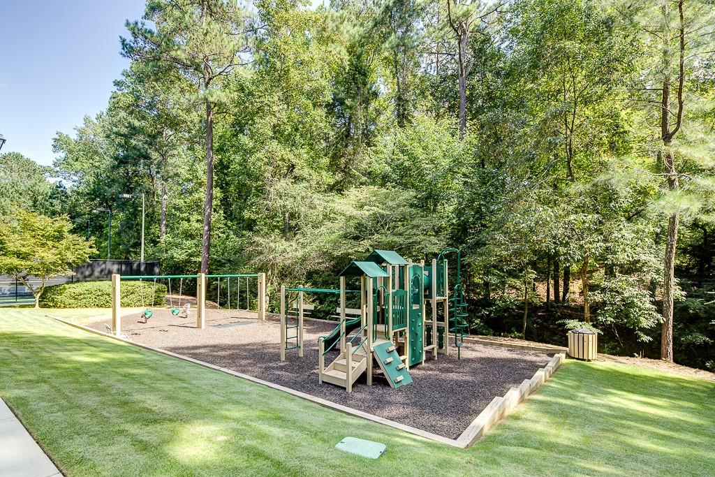 View of jungle gym with a lawn
