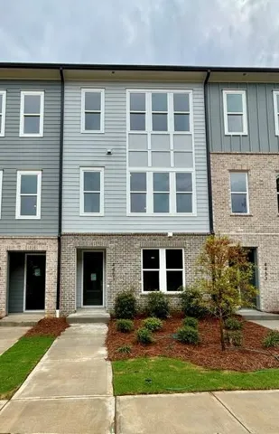 Multi-level facade featuring varied siding and brick