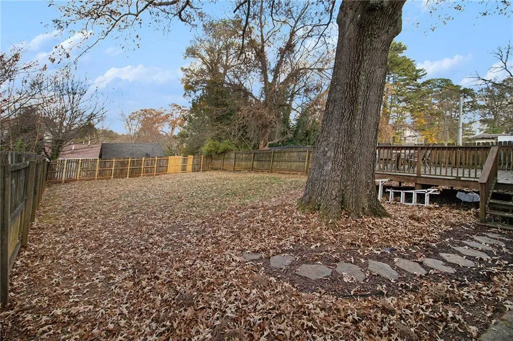 Fenced backyard with a deck