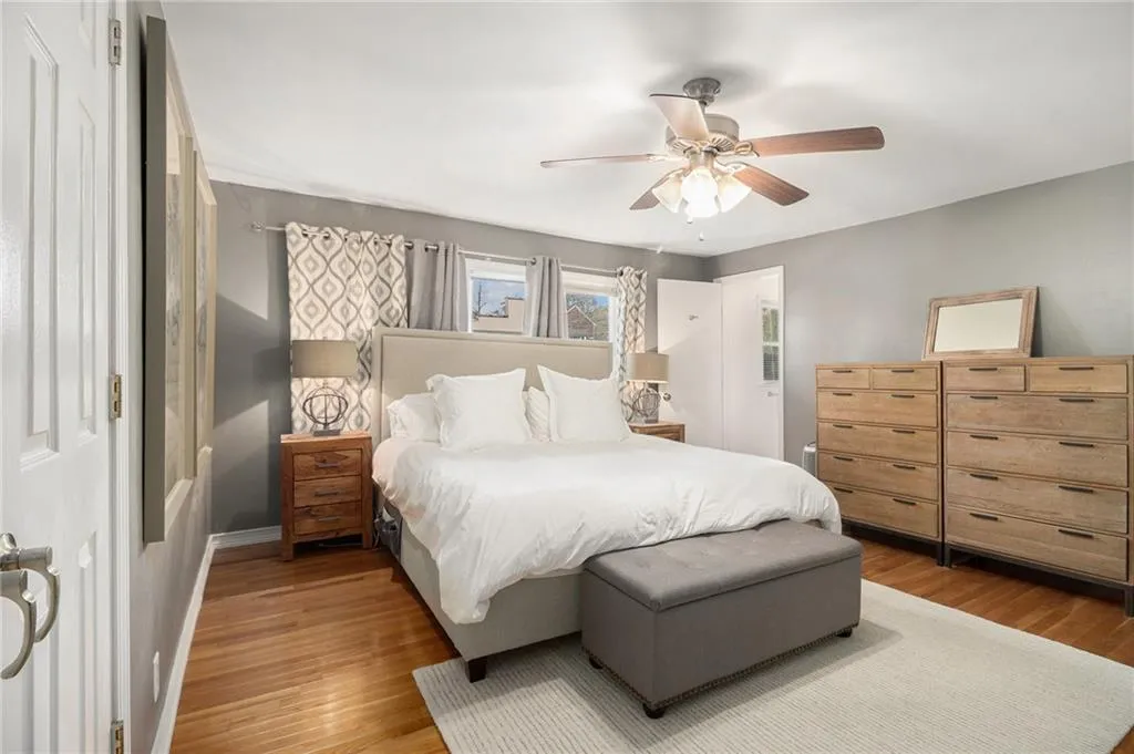 Bedroom with wood finished floors and ceiling fan