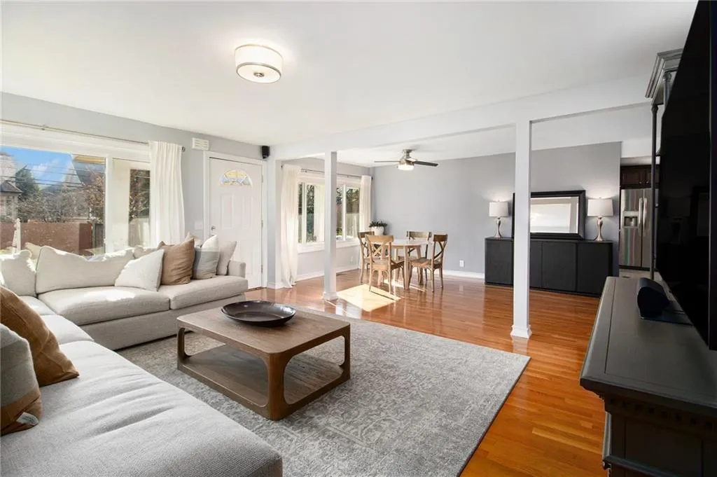 Living room featuring light wood-type flooring and ceiling fan
