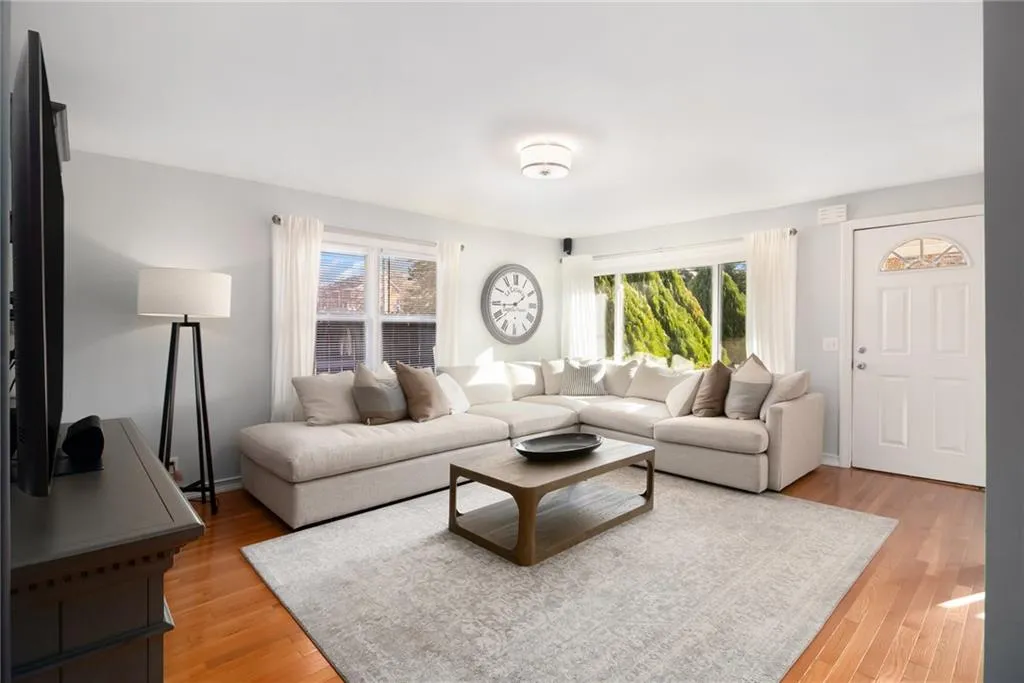 Living area featuring light wood-type flooring and baseboards
