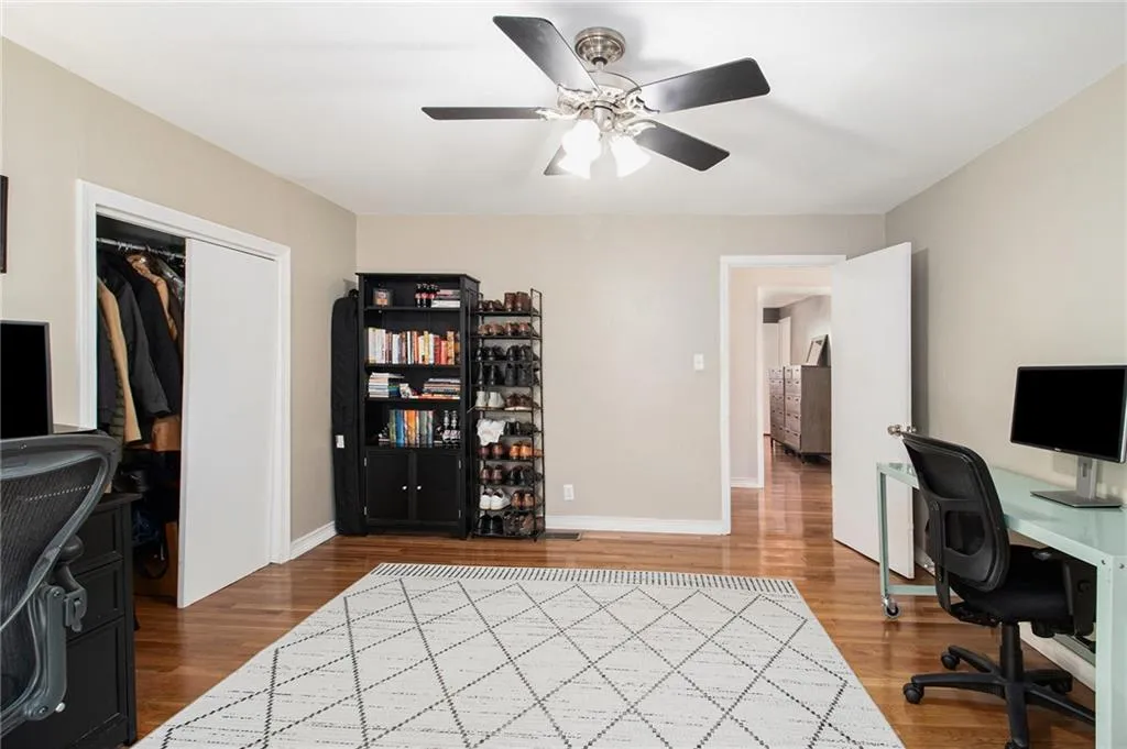 Office with light wood finished floors and ceiling fan