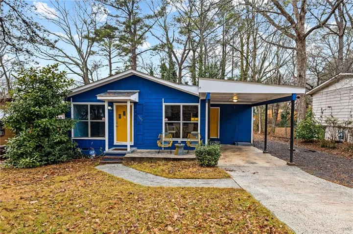 Vibrant blue exterior with a bright yellow front door, offering a welcoming facade