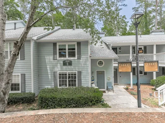 Light blue siding exterior featuring multiple windows with gray shutters