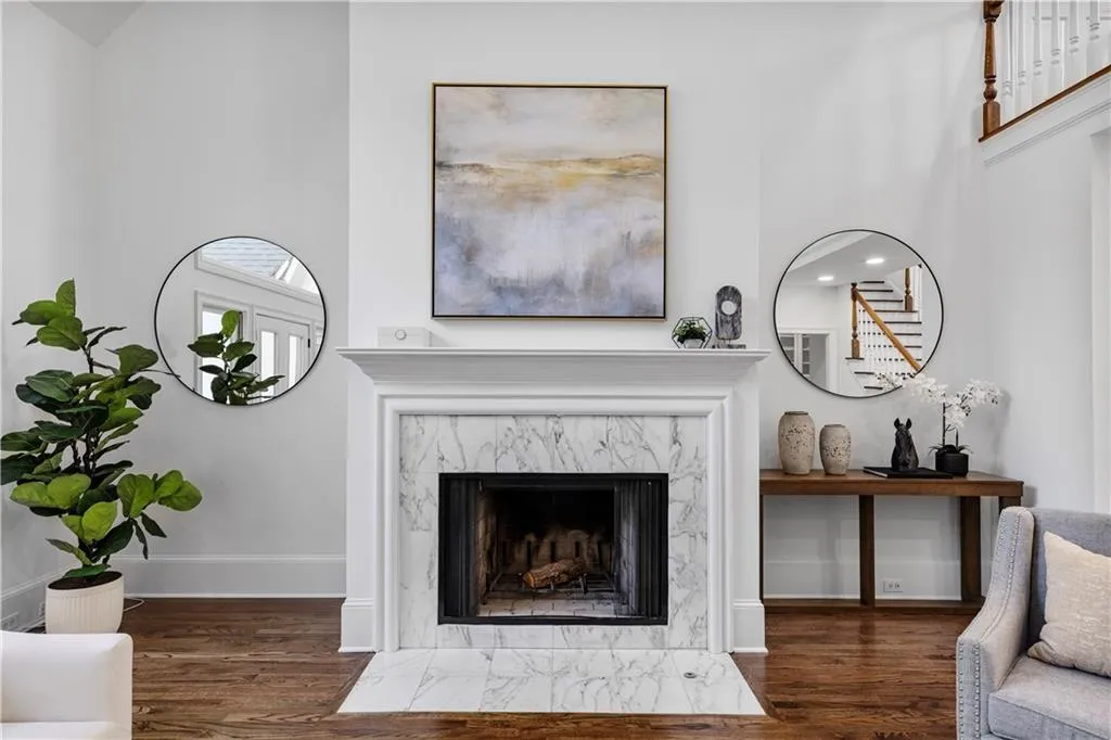 Living area featuring dark wood-type flooring and a fireplace