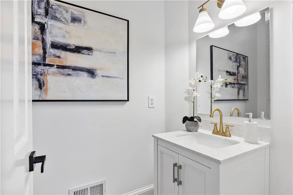 Bathroom featuring vanity and baseboards