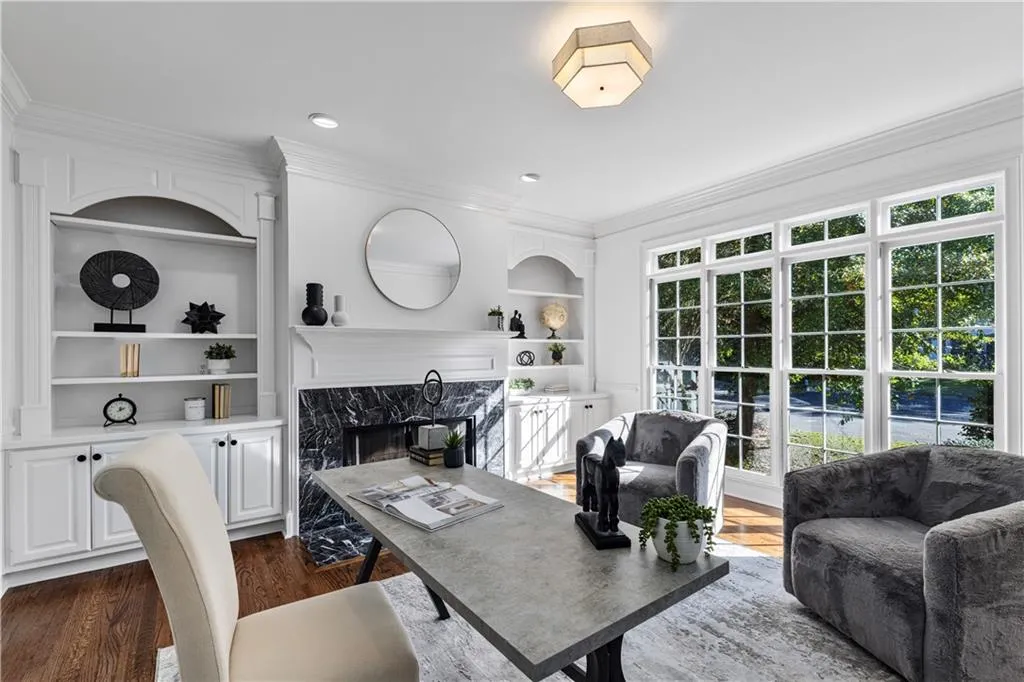 Office space with ornamental molding, dark wood-style floors, a high end fireplace, and recessed lighting