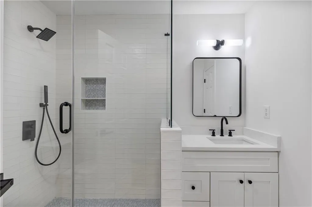 Bathroom featuring vanity and a shower stall
