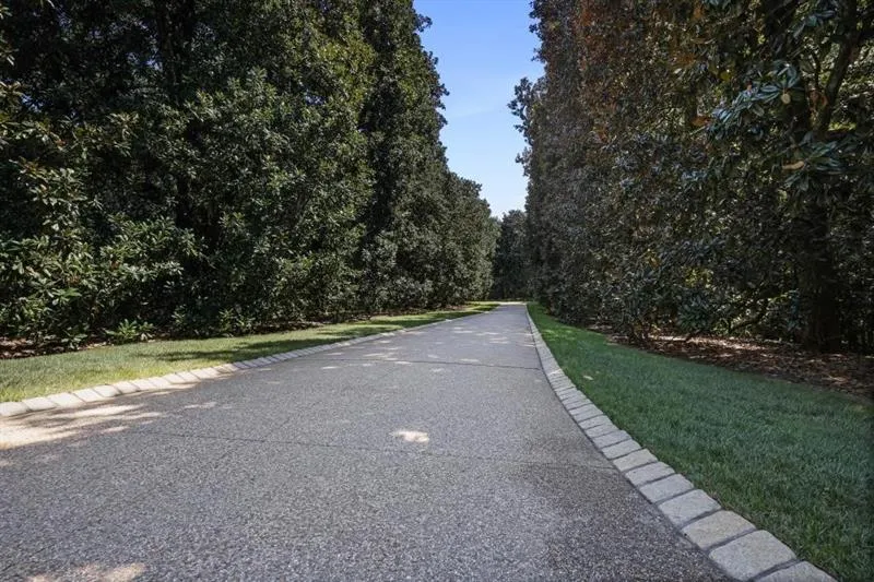 View of Long Driveway Leading toward Main Entrance and Tennis Court