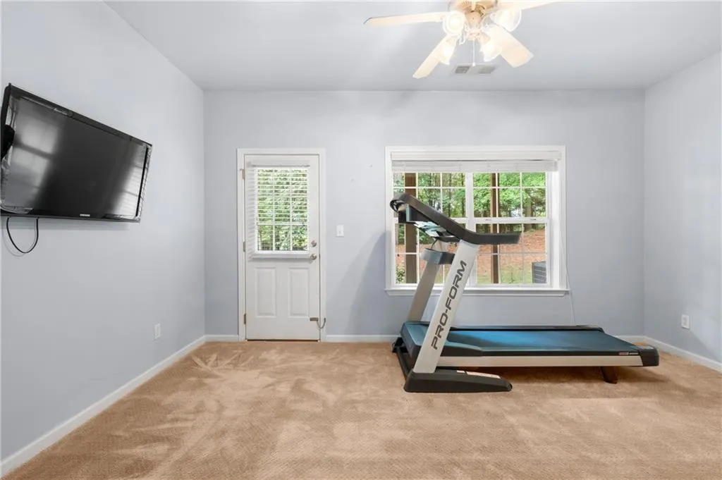 Terrace level 3rd bedroom also has a door leading out to the private wooded back area.