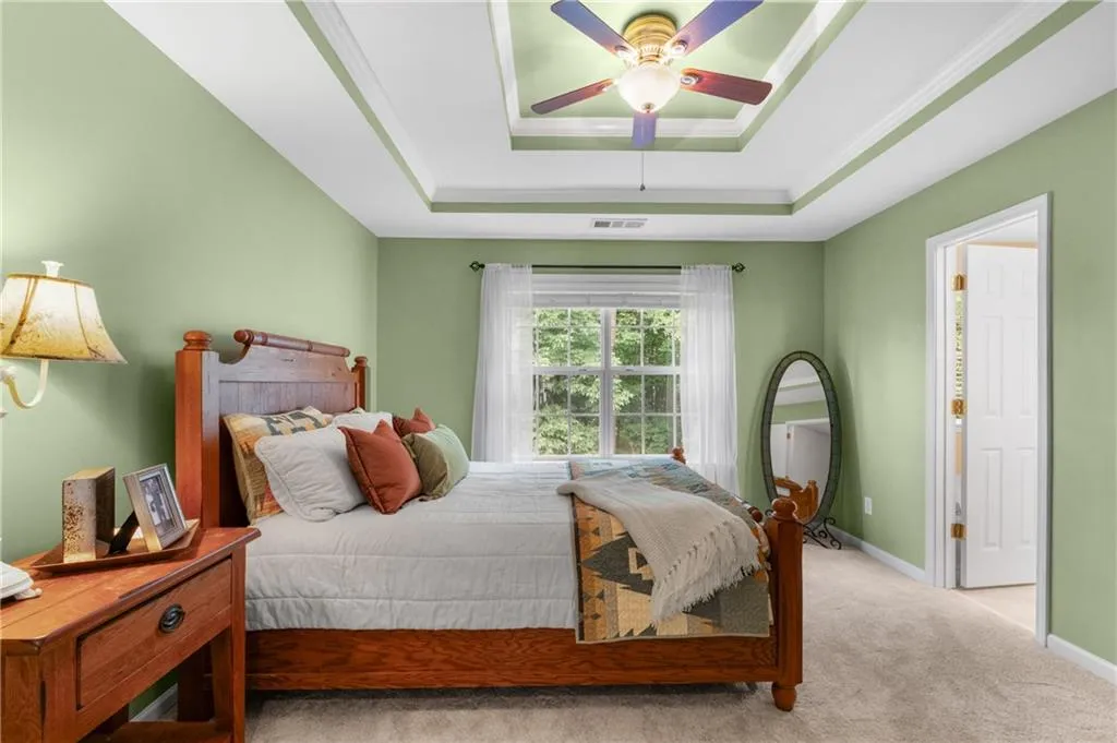 Newly installed plush carpeting on the entire 3rd level, the primary suite has a ceiling fan, a double tray ceiling and ensuite bath that overlooks the private wooded back area