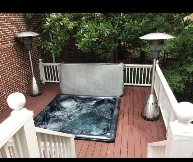 View of deck with hot tub and heaters