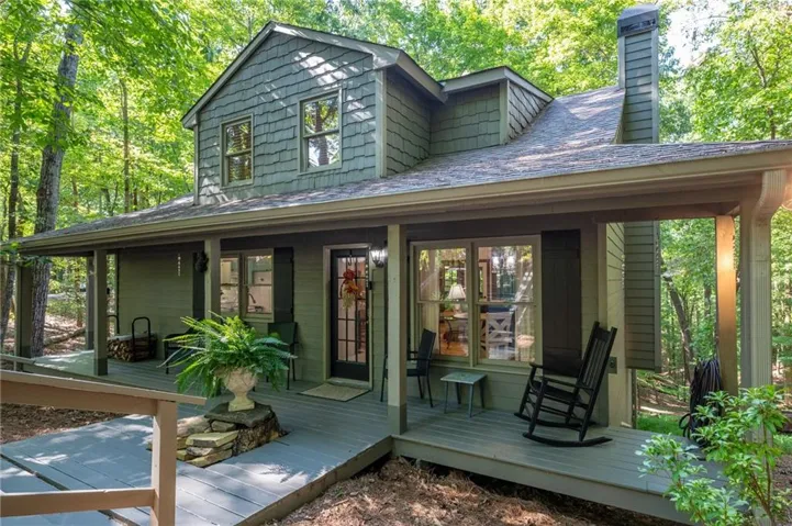 Gabled facade with shake siding, featuring an extended covered front porch