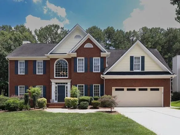 Brick exterior with light-colored siding accents and a contrasting dark roof