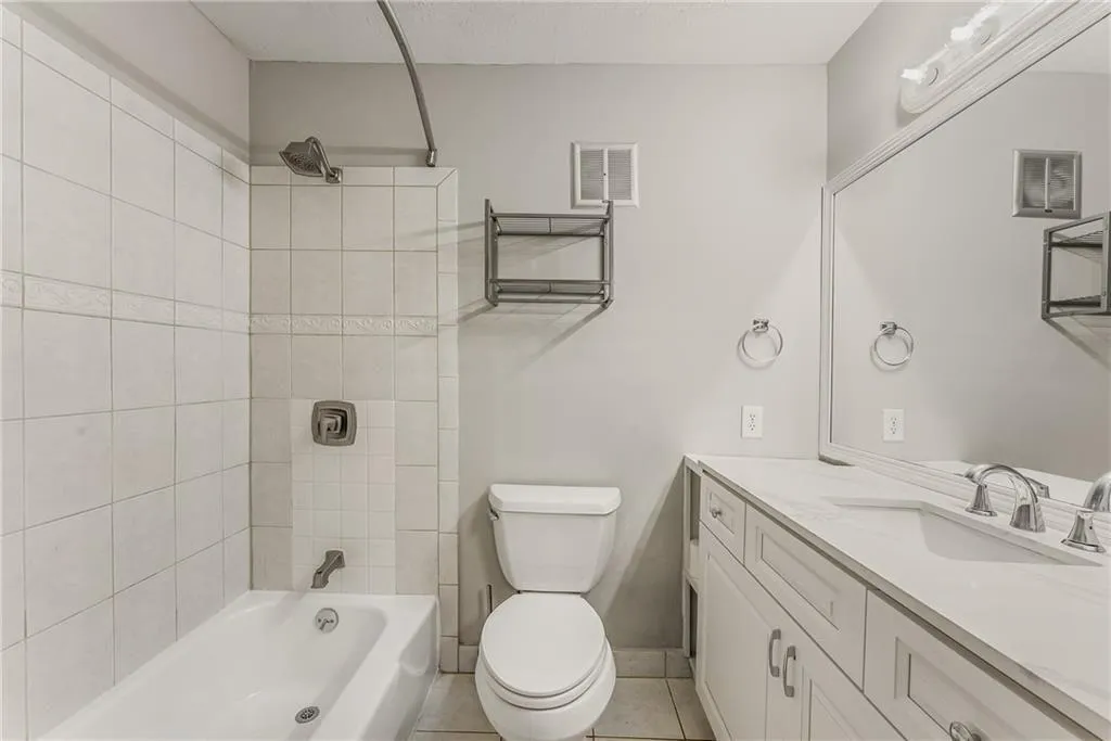 Refinished Bath, new cabinets, lighting, tub fixtures. Solid surface counters.