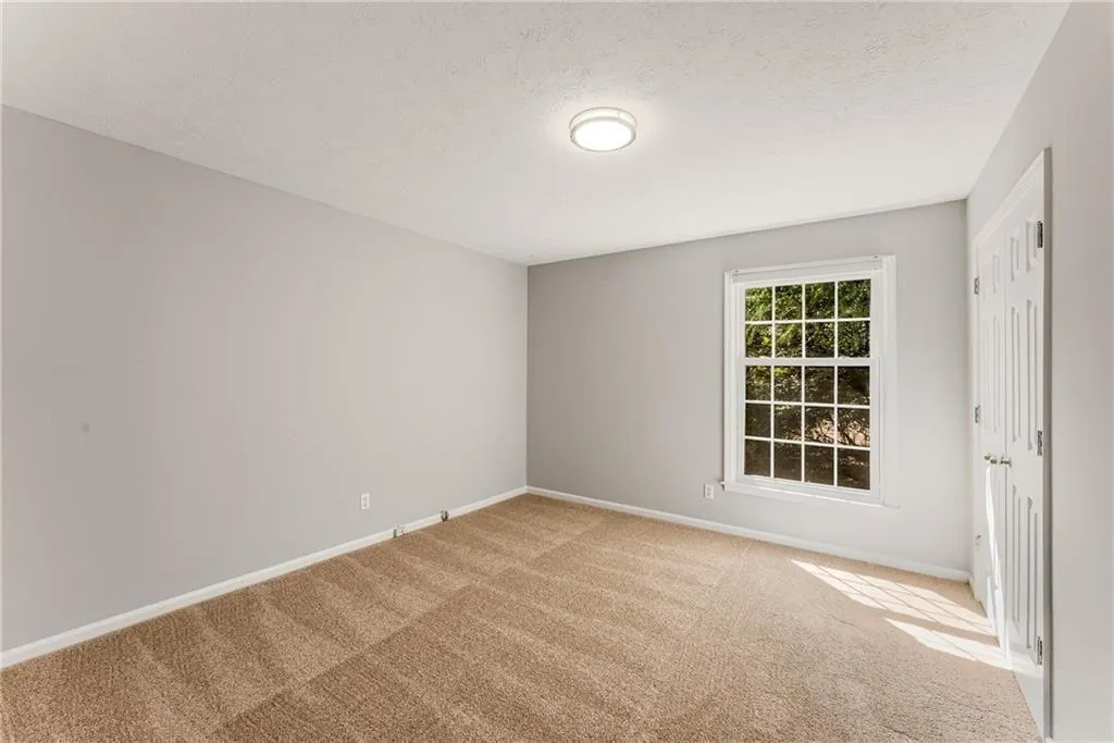 Larger of secondary bedrooms with new paint, carpet, lighting, blindds
