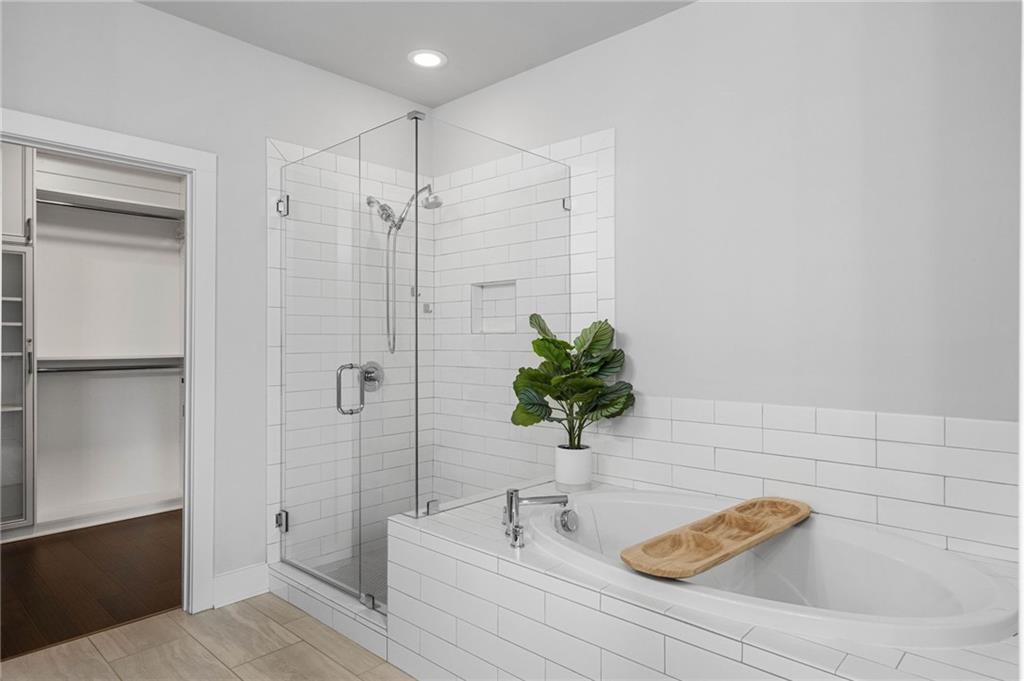 Bathroom featuring separate shower and tub and tile flooring