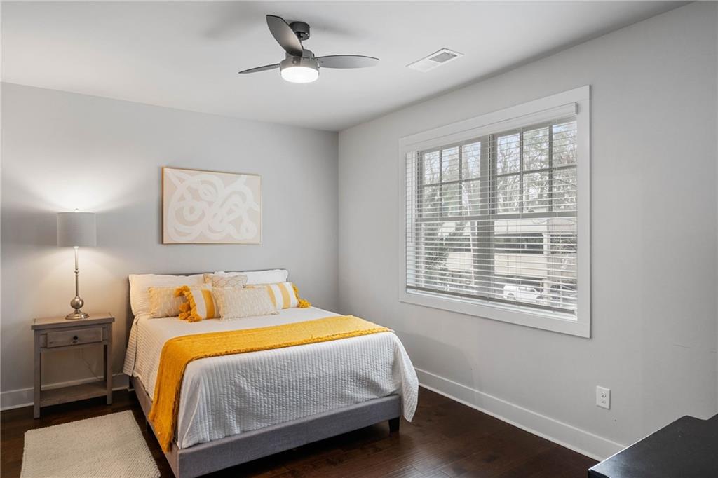 Bedroom featuring dark wood-type flooring and ceiling fan