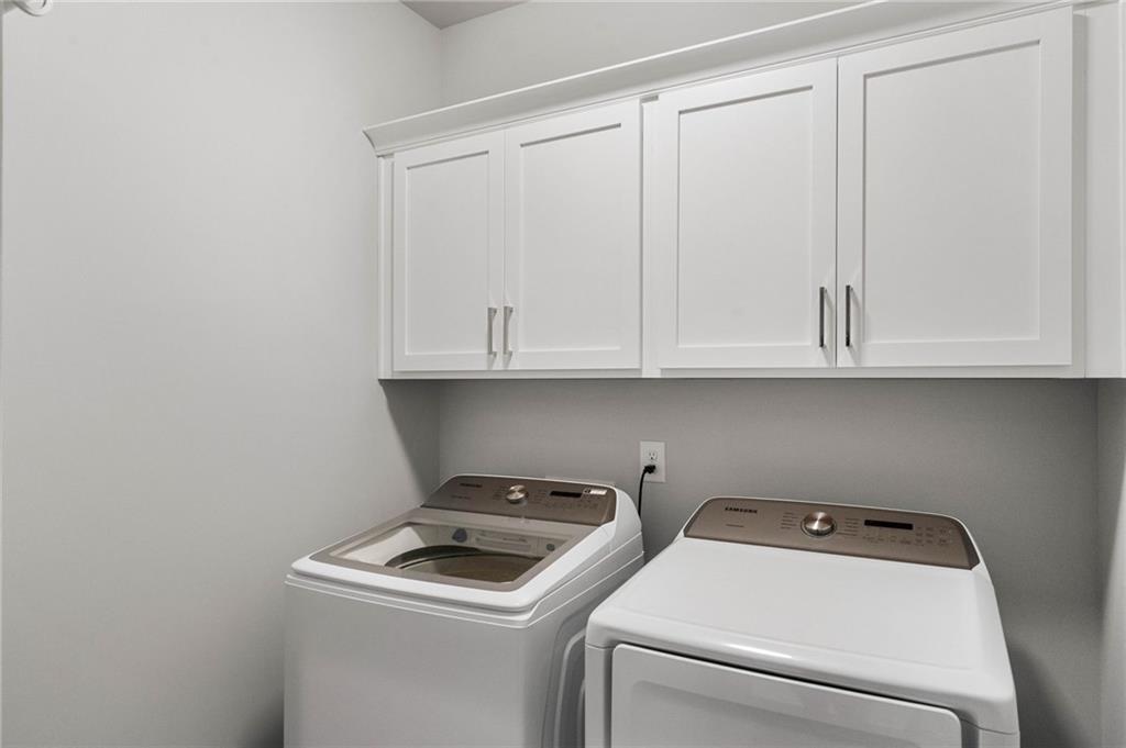 Laundry area featuring washer and dryer and cabinets