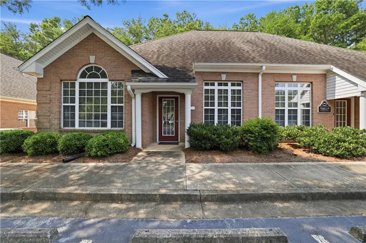 Brick facade with white trim and a gabled roofline
