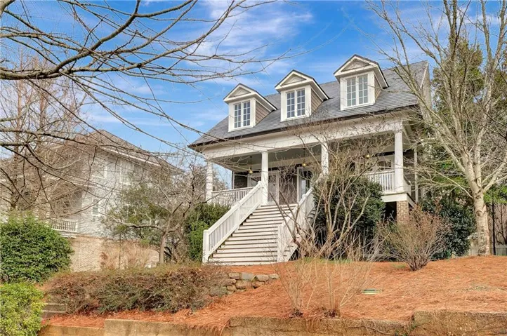 View of front of property with a porch and stairs