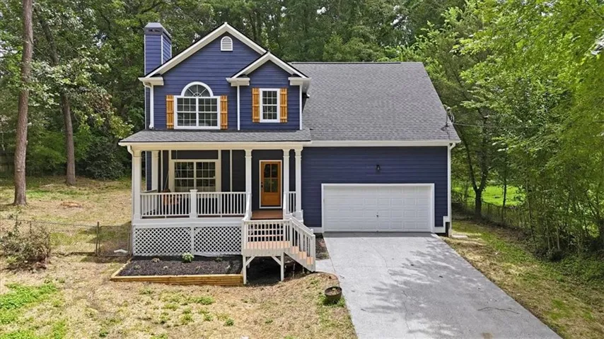 Two-story residence featuring a deep blue exterior and white trim