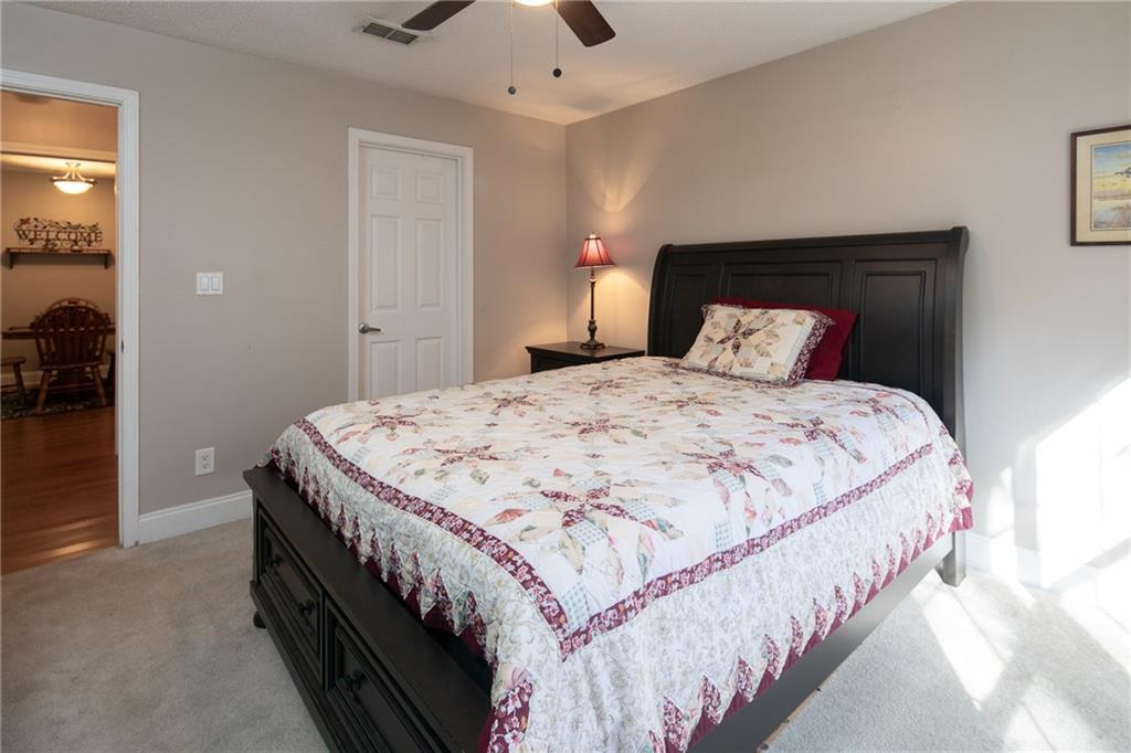 Carpeted bedroom featuring ceiling fan