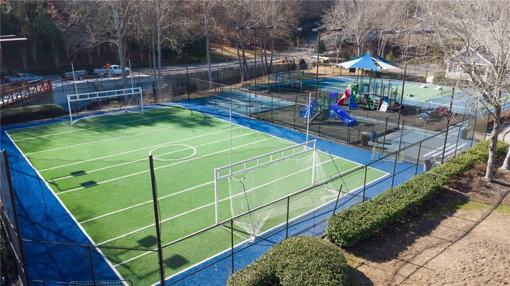 View of tennis court with a playground
