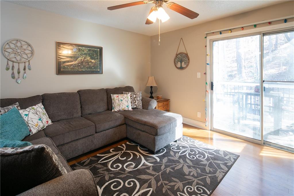 Living room featuring light hardwood / wood-style floors and ceiling fan