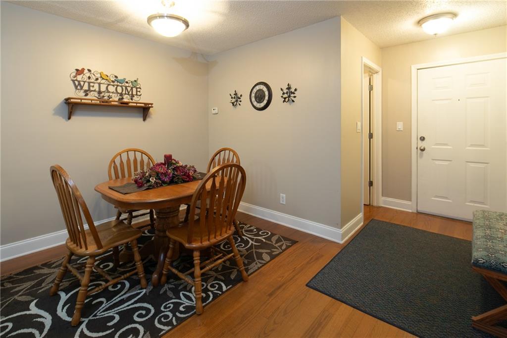 Dining room featuring dark wood-type flooring and a textured ceiling