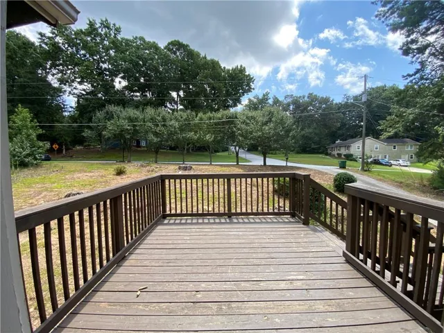 Expansive outdoor deck featuring wood-finish decking and perimeter railings