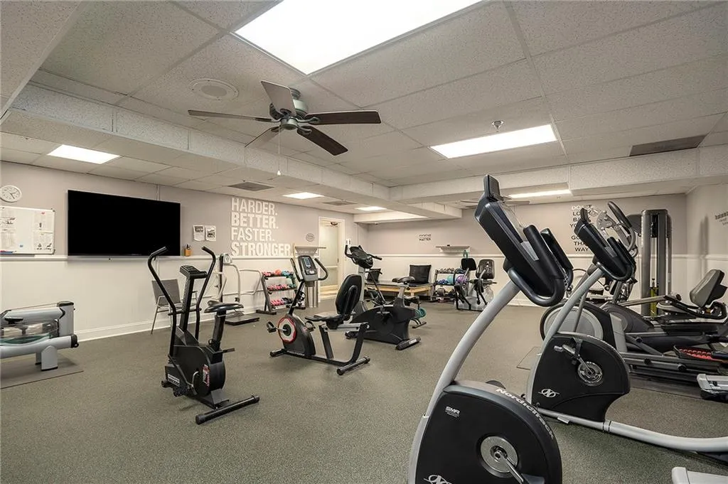 Gym featuring cardio and strength-building equipment.