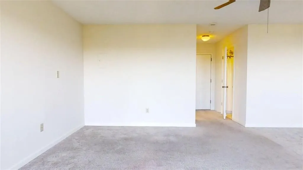 Spare room with carpet floors and a ceiling fan
