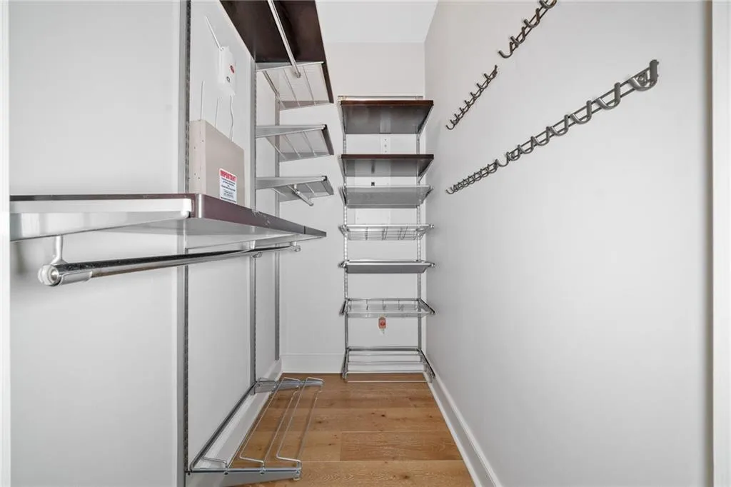 Walk in closet featuring light wood-style flooring