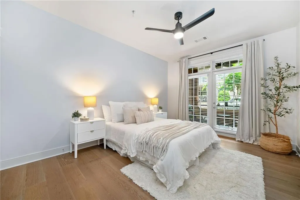 Bedroom featuring wood finished floors, access to exterior, ceiling fan, and baseboards