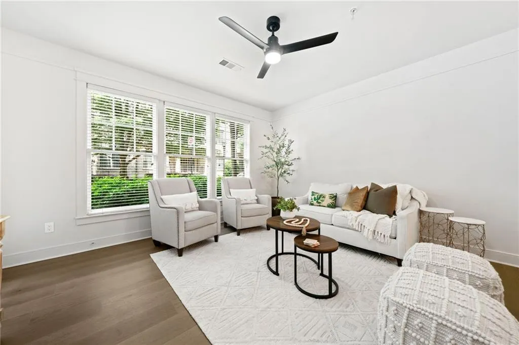 Living room featuring baseboards, ceiling fan, and wood finished floors