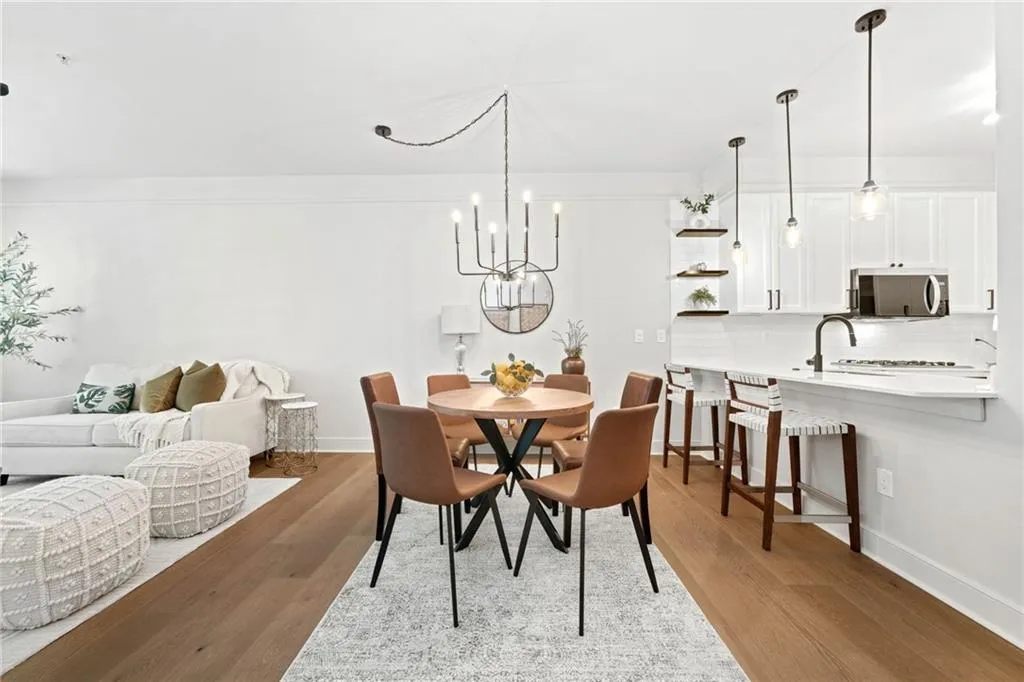 Dining area featuring wood finished floors, baseboards, and a chandelier