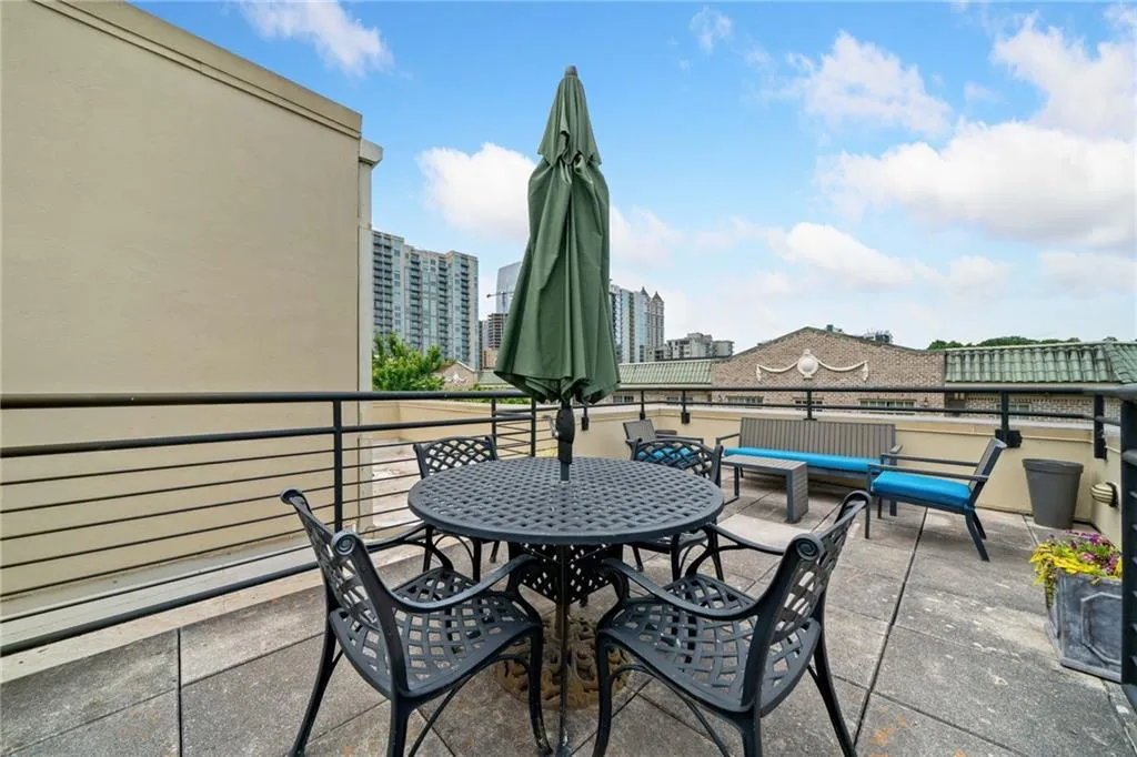 View of patio featuring a balcony and outdoor dining space