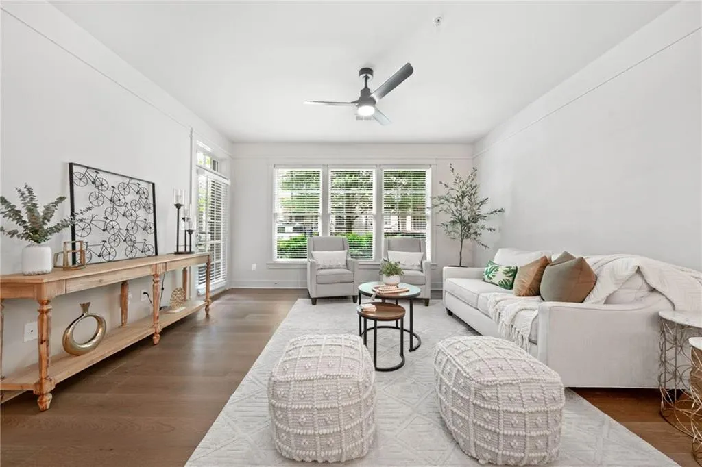 Living room featuring ceiling fan and wood finished floors